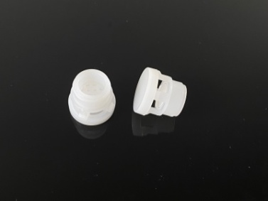 Spider chemical resistant vent plug, allows gas exchange while preventing leakage and packaging deformation